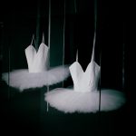 a couple of white ballet shoes sitting on top of a floor