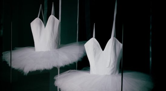 a couple of white ballet shoes sitting on top of a floor